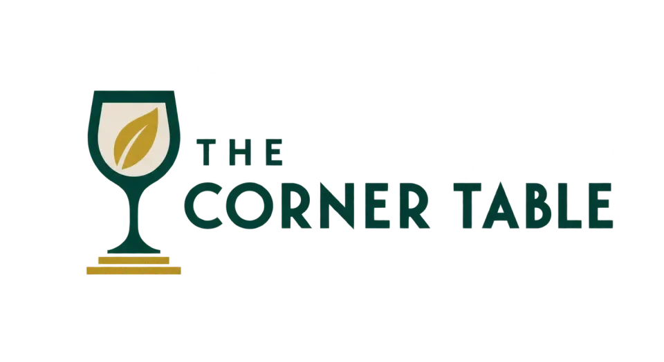 The Corner Table combination mark logo idea: A leaf inside a simple wine glass gives The Corner Table a welcoming dining cue with a little Deco character.