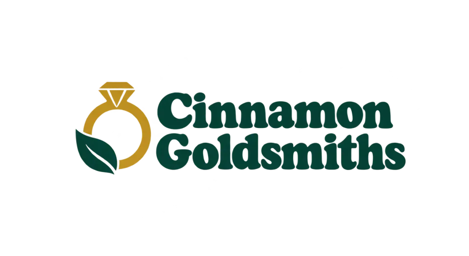Cinnamon Goldsmiths combination mark logo idea: A simple gold ring with one green leaf gives Cinnamon Goldsmiths a jewelry-first look with an earthy touch.