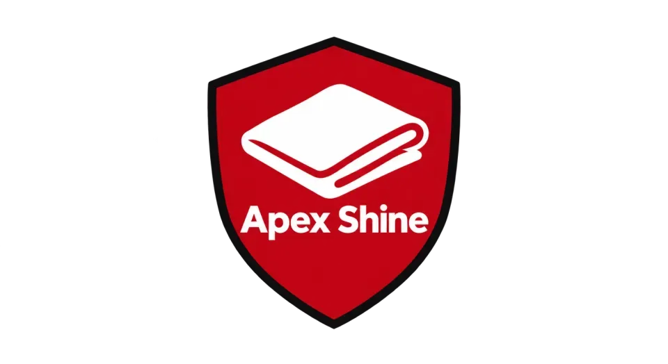 Apex Shine emblem logo idea: A simple cloth at the heart of a red shield makes the detailing service clear and gives “Apex Shine” a fast, confident badge.