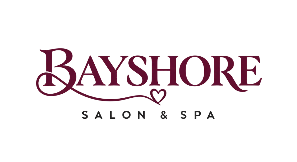 Bayshore Salon & Spa wordmark logo idea: A composed two-line name feels easy to read and welcoming, with a small strand-shaped heart adding a subtle salon-specific detail.