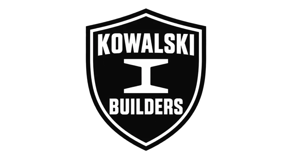 Kowalski Builders emblem logo idea: A clean shield and central steel I-beam give Kowalski Builders a straightforward badge that feels built for the job.