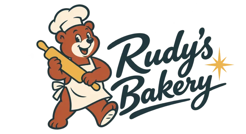 Rudy's Bakery mascot logo idea: A cheerful bear with a rolling pin gives Rudy's Bakery a friendly storefront feel, while the bold script keeps the name easy to spot.