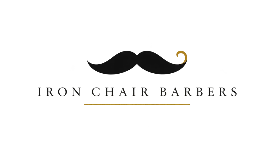 Iron Chair Barbers combination mark logo idea: A classic mustache and quiet gold accents give Iron Chair Barbers a polished, boutique feel without crowding the name.