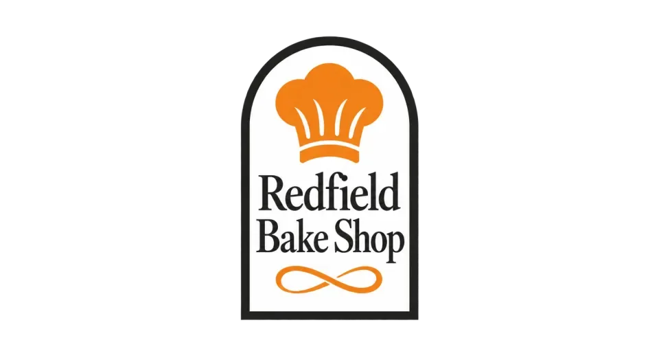Redfield Bake Shop emblem logo idea: The tall outline gives the centered hat and stacked name a clear, easy-to-spot shape from a distance.